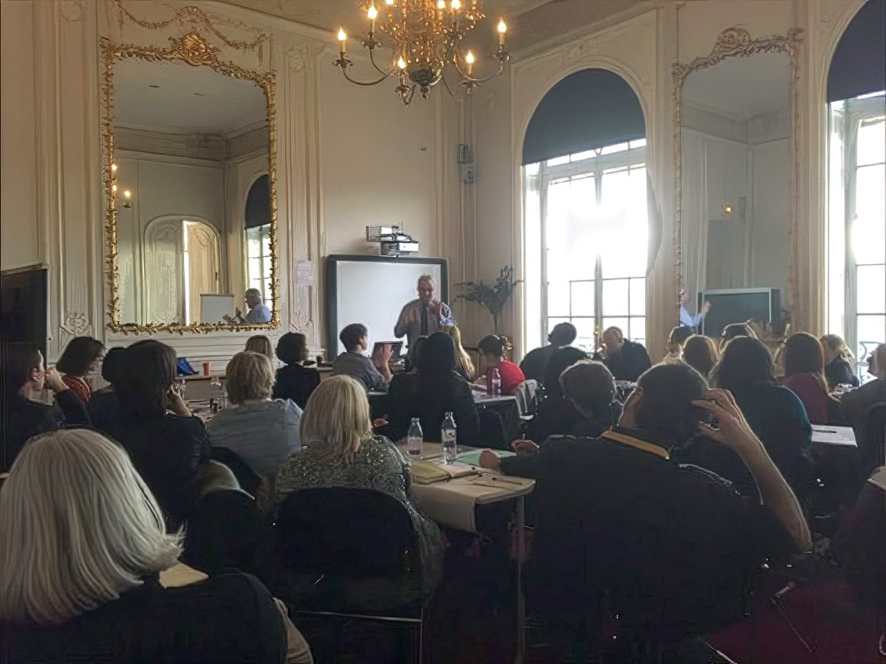 Participants attending an ELSA Spotlight lectured, seated in a dimly lit building